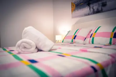 a bed with a towel laying on top of it at Cozy Barrie Home - Minutes to College & Hospital in Barrie