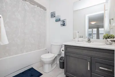 a bathroom with a toilet and a sink and a shower at Luxury Living 5 mins from the Falls in Niagara Falls