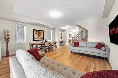 a living room with a couch and a dining room at Modern 5 Bed Home Near Burlington Pier, Downtown, Hospital, GO in Burlington