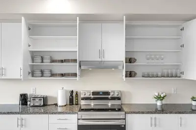 a kitchen with white cabinets and stainless steel appliances at Modern 5 Bed Home Near Burlington Pier, Downtown, Hospital, GO in Burlington