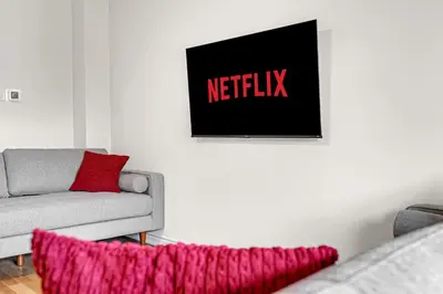 a living room with a couch and a sign on the wall at Modern 5 Bed Home Near Burlington Pier, Downtown, Hospital, GO in Burlington