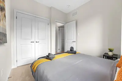 a bedroom with a large bed with towels on it at Modern 5 Bed Home Near Burlington Pier, Downtown, Hospital, GO in Burlington