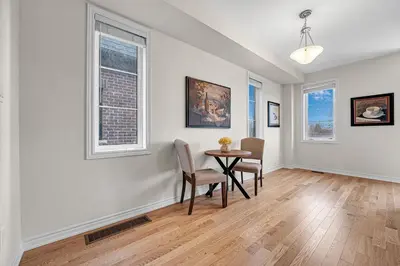 an empty living room with a table and chairs at Modern 5 Bed Home Near Burlington Pier, Downtown, Hospital, GO in Burlington