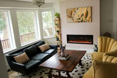 a living room with a couch and a fireplace at Large Waterfront Home w 5 Ensuite Bathrooms in Belleville