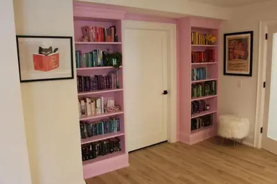 a room with pink book shelves filled with books at Large Waterfront Home w 5 Ensuite Bathrooms in Belleville