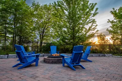 three blue chairs sitting around a fire pit at The Tree Frog - 12 Pine Forest in Cherry Valley