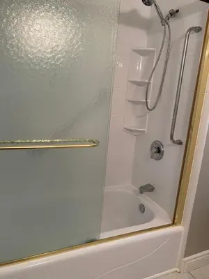 a shower with a glass door in a bathroom at Cheerful 4 bedroom with sunroom in Belleville