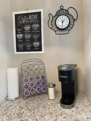 a counter with a trash can and a clock on the wall at Cheerful 4 bedroom with sunroom in Belleville