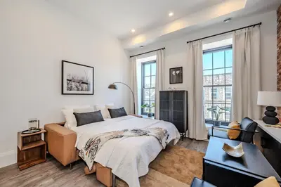 a white bedroom with a bed and a couch at Charming 2 Bed Apartment in Cambridge