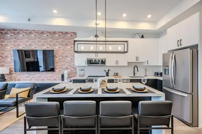 a kitchen with a table and chairs and a refrigerator at Charming 2 Bed Apartment in Cambridge