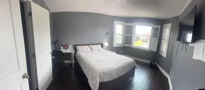 a bedroom with a bed and two windows at Q88 luxury Sunny room in Mississauga