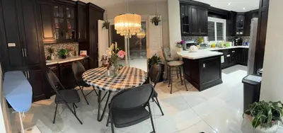 a kitchen with a table and chairs in a kitchen at F3 Spacious room with 2 queen beds and TV in Mississauga