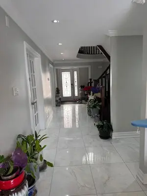 a living room with a hallway with potted plants at F1 cozy Sunny room in Mississauga