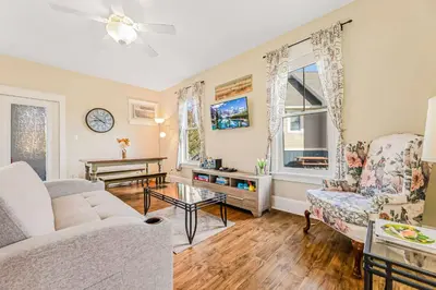 a living room with a couch and a table at The Lynx - 35 Butternut in Cherry Valley