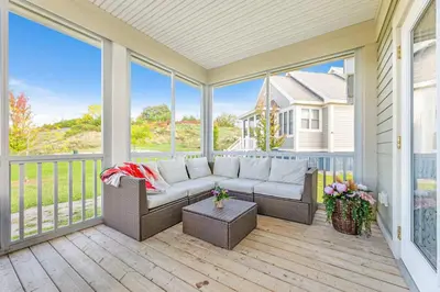 a screened in porch with a couch and a table at The Lynx - 35 Butternut in Cherry Valley