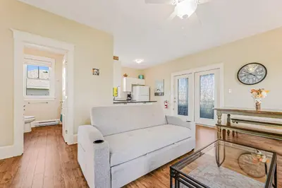 a living room with a couch and a piano at The Lynx - 35 Butternut in Cherry Valley