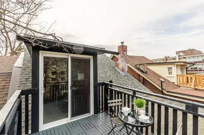 a black deck with a table and chairs on it at Modern City Suite with Rooftop Patios in Toronto