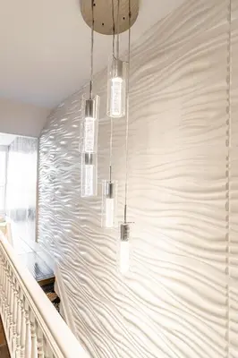 a hallway with three chandeliers hanging from a wall at Modern City Suite with Rooftop Patios in Toronto