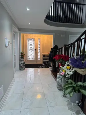 a hallway with a front door with flowers and plants at F2 Comfy Private Room in city square one in Mississauga