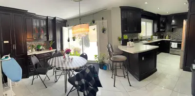 a kitchen with a table and chairs and a kitchen with a counter at F2 Comfy Private Room in city square one in Mississauga