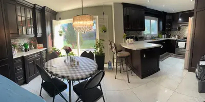 a kitchen with a table and chairs and a dining room at F2 Comfy Private Room in city square one in Mississauga