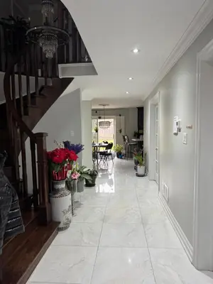 a hallway of a house with a staircase and flowers at F2 Comfy Private Room in city square one in Mississauga