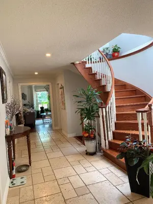 a hallway with a staircase in a home with potted plants at 201 Large Private Bedroom on second floor in Mississauga
