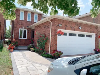 a brick house with a white garage at 201 Large Private Bedroom on second floor in Mississauga