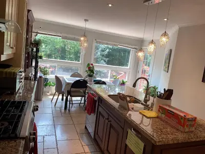 a kitchen with a counter top and a dining room at 201 Large Private Bedroom on second floor in Mississauga