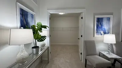 a living room with a chair and a table with a plant at Exquisite Luxury Townhomes in Elite Angus Glen Estate in Markham