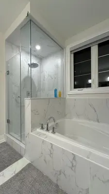 a white bathroom with a tub and a glass shower at Exquisite Luxury Townhomes in Elite Angus Glen Estate in Markham