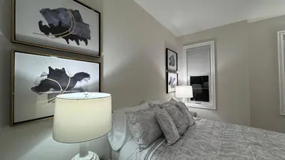 a bedroom with a bed and pictures on the wall at Exquisite Luxury Townhomes in Elite Angus Glen Estate in Markham