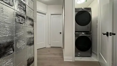 a hallway with a washer and dryer in a house at Exquisite Luxury Townhomes in Elite Angus Glen Estate in Markham