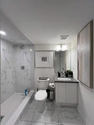 a white bathroom with a toilet and a sink at Exquisite Luxury Townhomes in Elite Angus Glen Estate in Markham