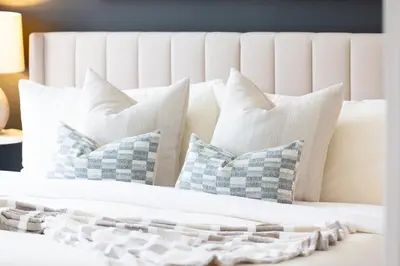 a white bed with four pillows on it at Modern 1BR King Suite, Central Downtown Toronto in Toronto