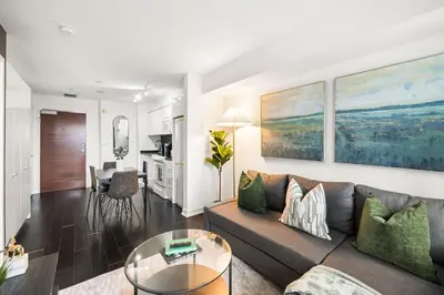 a living room with a couch and a table at Modern 1BR King Suite, Central Downtown Toronto in Toronto