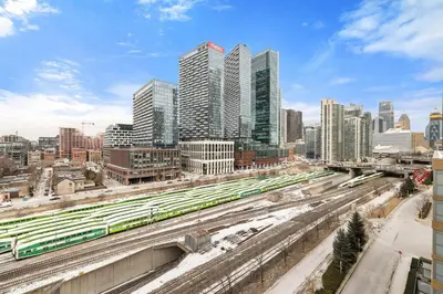 a view of a city with train tracks and buildings at Modern 1BR King Suite, Central Downtown Toronto in Toronto