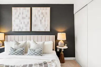 a bedroom with a white bed with blue pillows at Modern 1BR King Suite, Central Downtown Toronto in Toronto