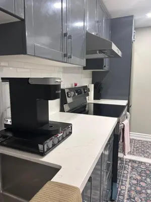 a kitchen with stainless steel cabinets and a counter top at Private 2bedroom Unit, Free Parking, Free from Smoke & Pet, Self-Check IN in Pickering