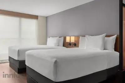 a bedroom with two beds with white pillows at Hyatt Place Mississauga / Airport Corp Center in Mississauga