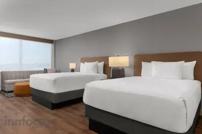 a hotel room with two beds and a couch at Hyatt House Mississauga / Airport Corp Center in Mississauga