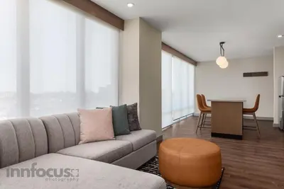 a living room with a couch and a table at Hyatt House Mississauga / Airport Corp Center in Mississauga