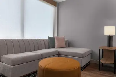 a living room with a couch and a table at Hyatt House Mississauga / Airport Corp Center in Mississauga