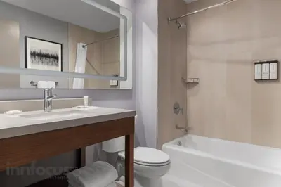 a bathroom with a sink and a toilet and a tub at Hyatt House Mississauga / Airport Corp Center in Mississauga