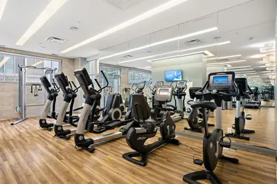 a gym with treadmills and elliptical machines at Luxurious Suite in Yorkville in Toronto