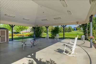 a large covered patio with a table and chairs at The Amanita - 9 Hollow in Cherry Valley