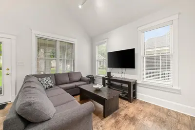 a living room with a couch and a flat screen tv at The Amanita - 9 Hollow in Cherry Valley