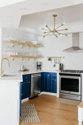 a kitchen with blue cabinets and a ceiling at Marina and Main - In Ground Pool and Games Room in Wellington