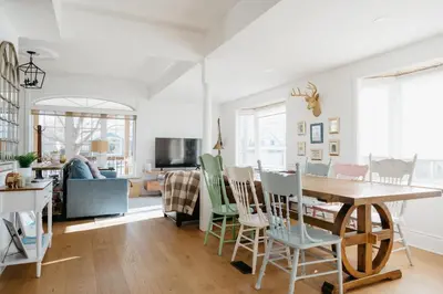 a kitchen and living room with a table and chairs at Marina and Main - In Ground Pool and Games Room in Wellington
