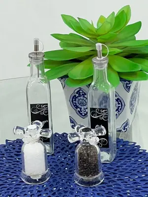 two glass bottles sitting on a table with a vase at St Catharines Niagara Escape in St. Catharines
